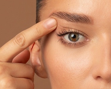blepharoplasty near me patient pointing at eye